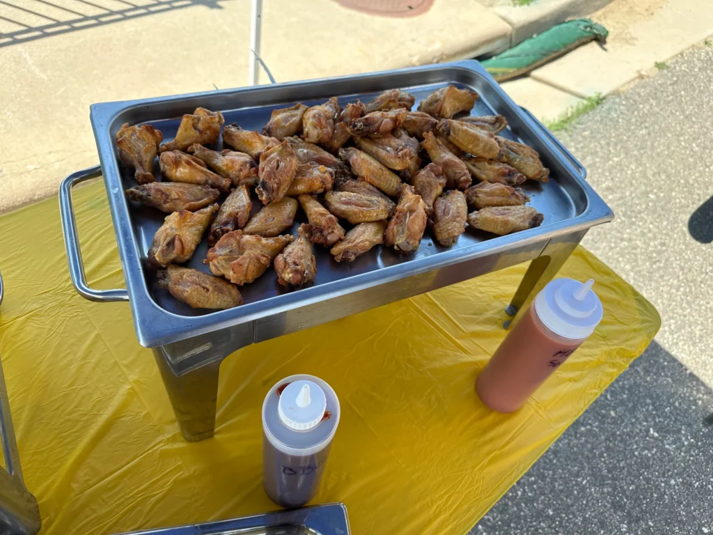Tray of grilled chicken wings served at an outdoor event